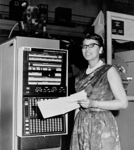 Melba Roy Mouton, standing with computing equipment at Goddard Space Flight Center.
